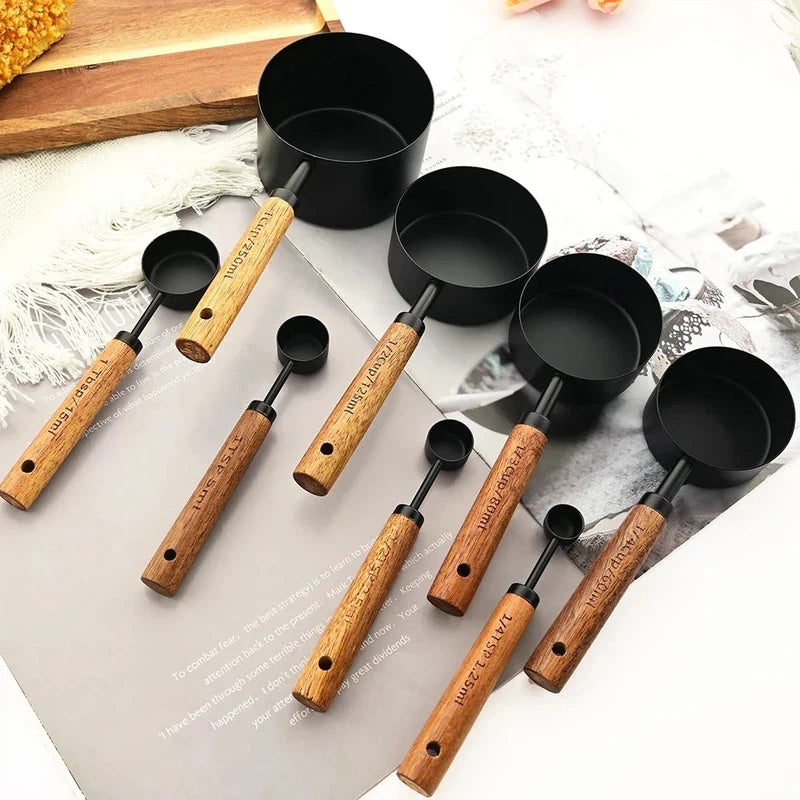 8-piece stainless steel measuring cups and spoons set with wooden handles in black, ideal for baking and bartending.