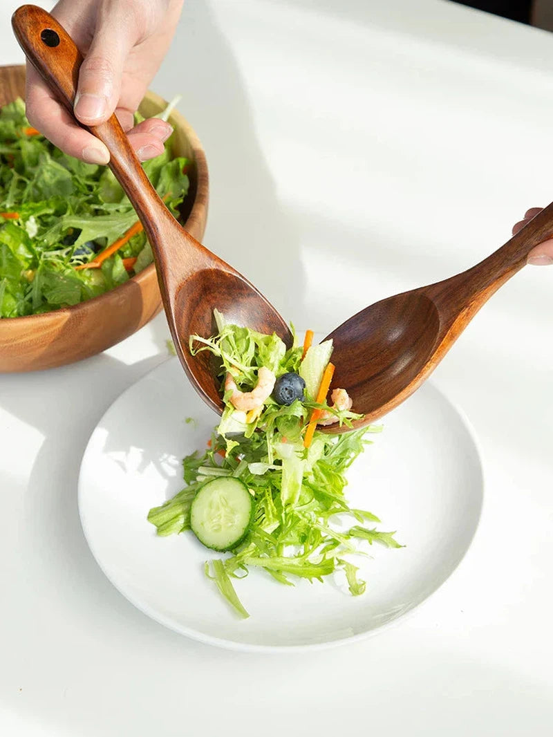 Wooden spoon and fork set serving salad, Japanese style, eco-friendly kitchen utensil.