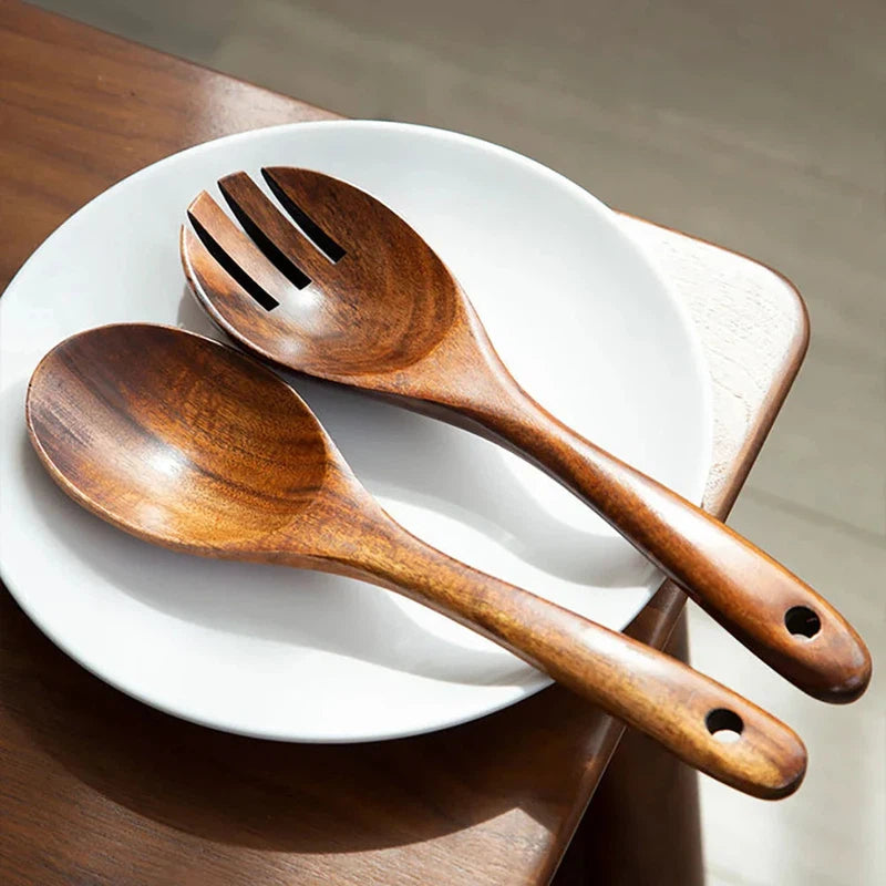 2Pcs wooden large spoon and fork cutlery set on white plate, Japanese style with long handles for serving salad.