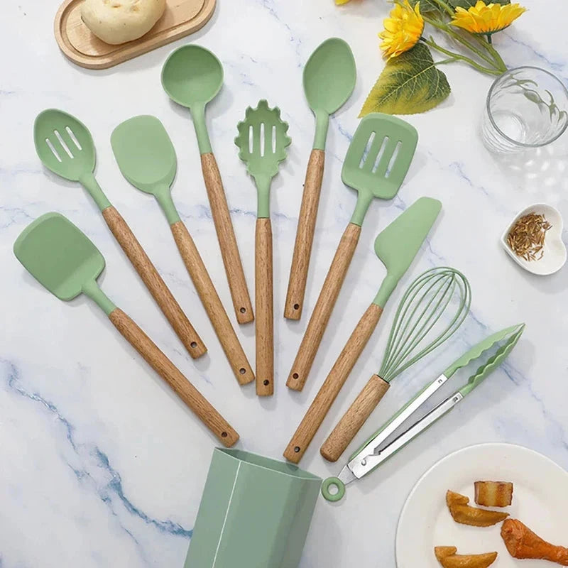 11-piece silicone cooking utensils set with wooden handles on kitchen counter.