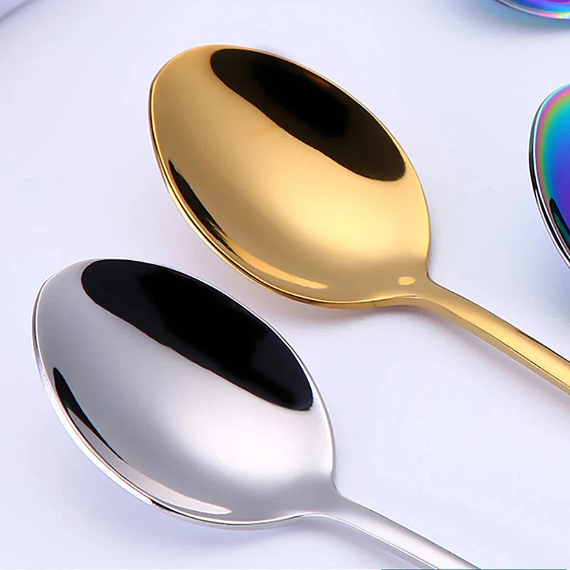 Stainless steel cutlery set with long handle spoons in gold and silver finish.