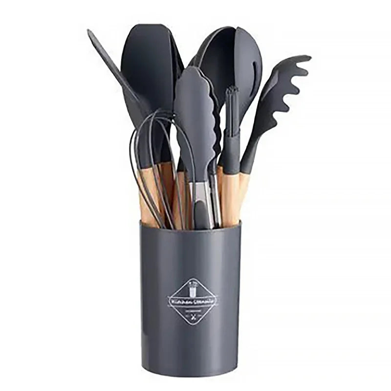 12-piece silicone kitchen utensil set with wooden handles in storage bucket.