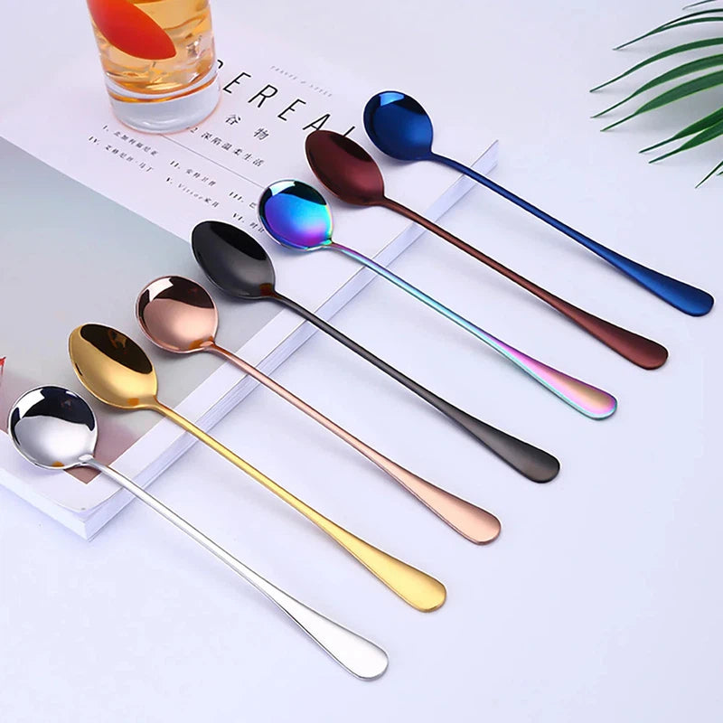 6Pcs stainless steel long handle dessert spoons in various colors displayed on a table.