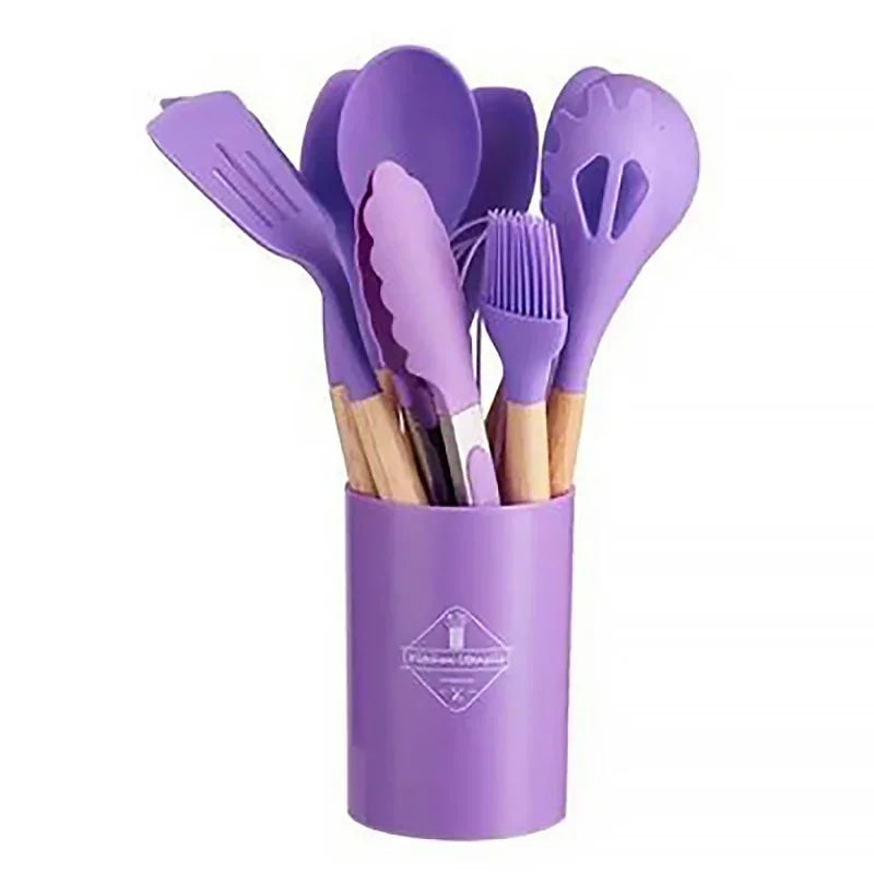 12-piece silicone kitchen utensil set with wooden handles in a purple storage bucket.